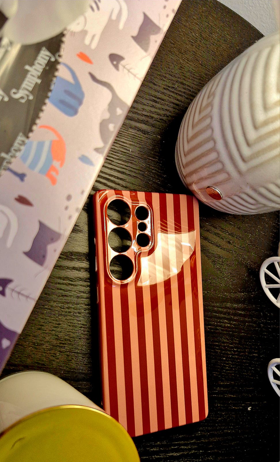 Red stripe glossy phone case on dark wood surface