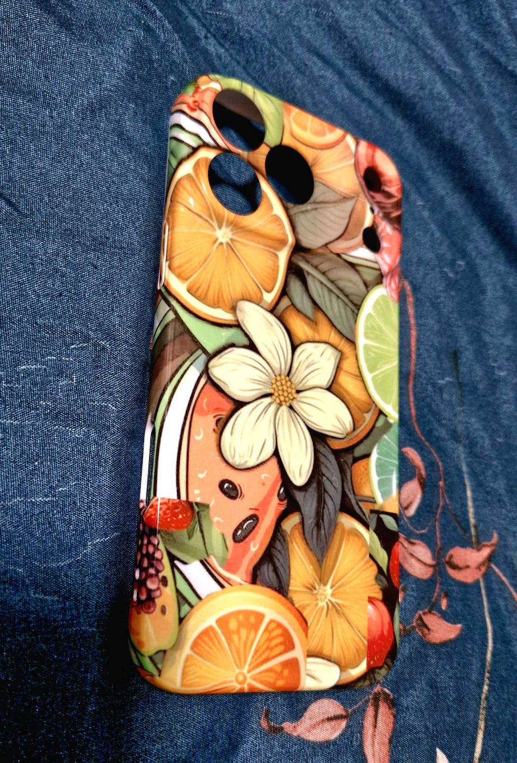 Tropical fruit and floral phone case close-up on fabric