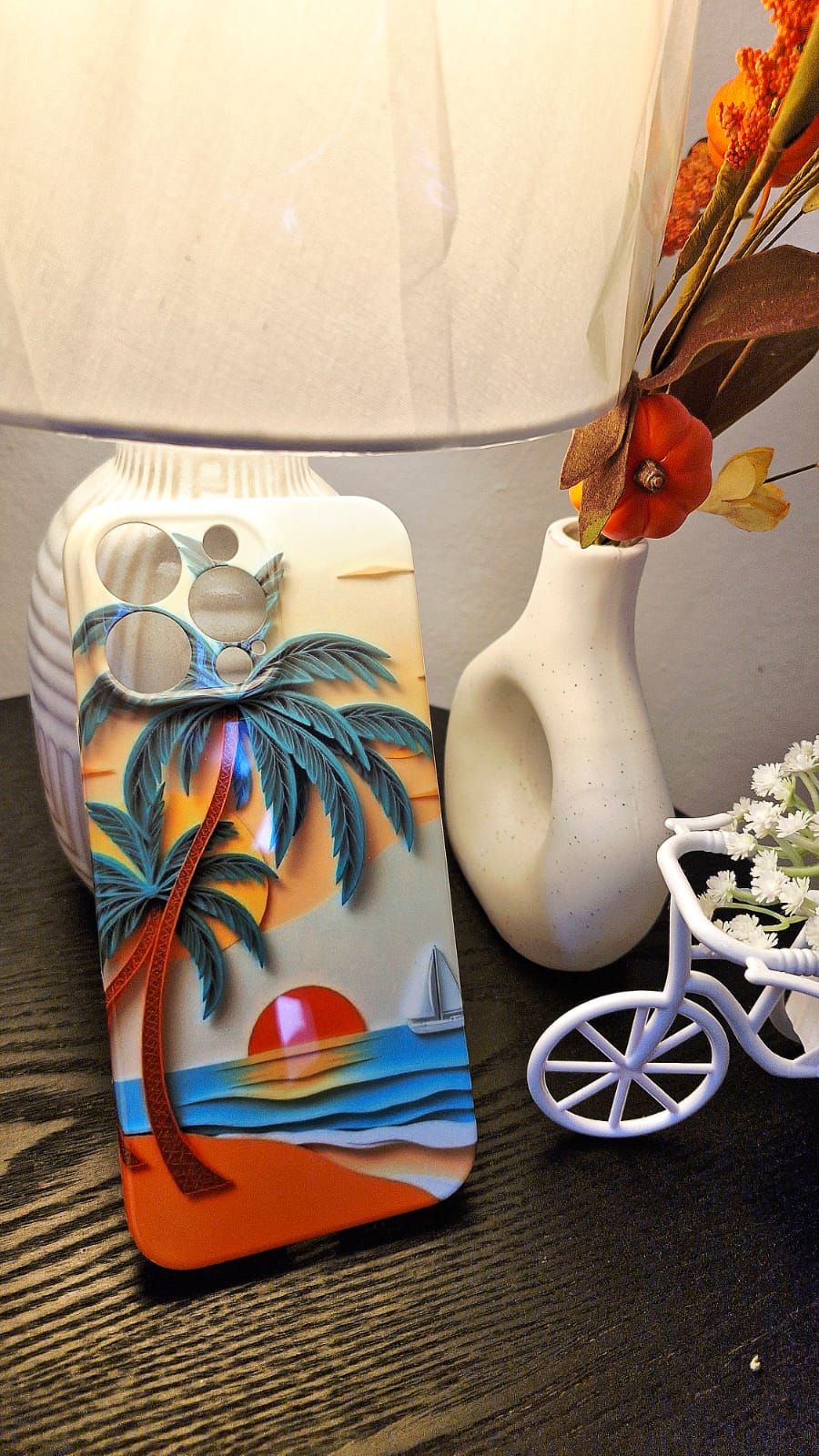 Sunset palm tree phone case lifestyle shot with home decor