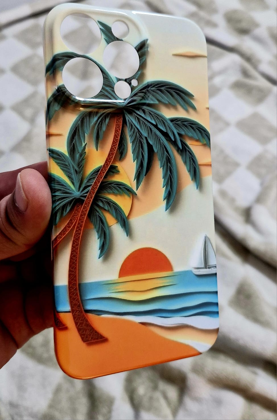 Sunset palm tree phone case held in hand showing front design