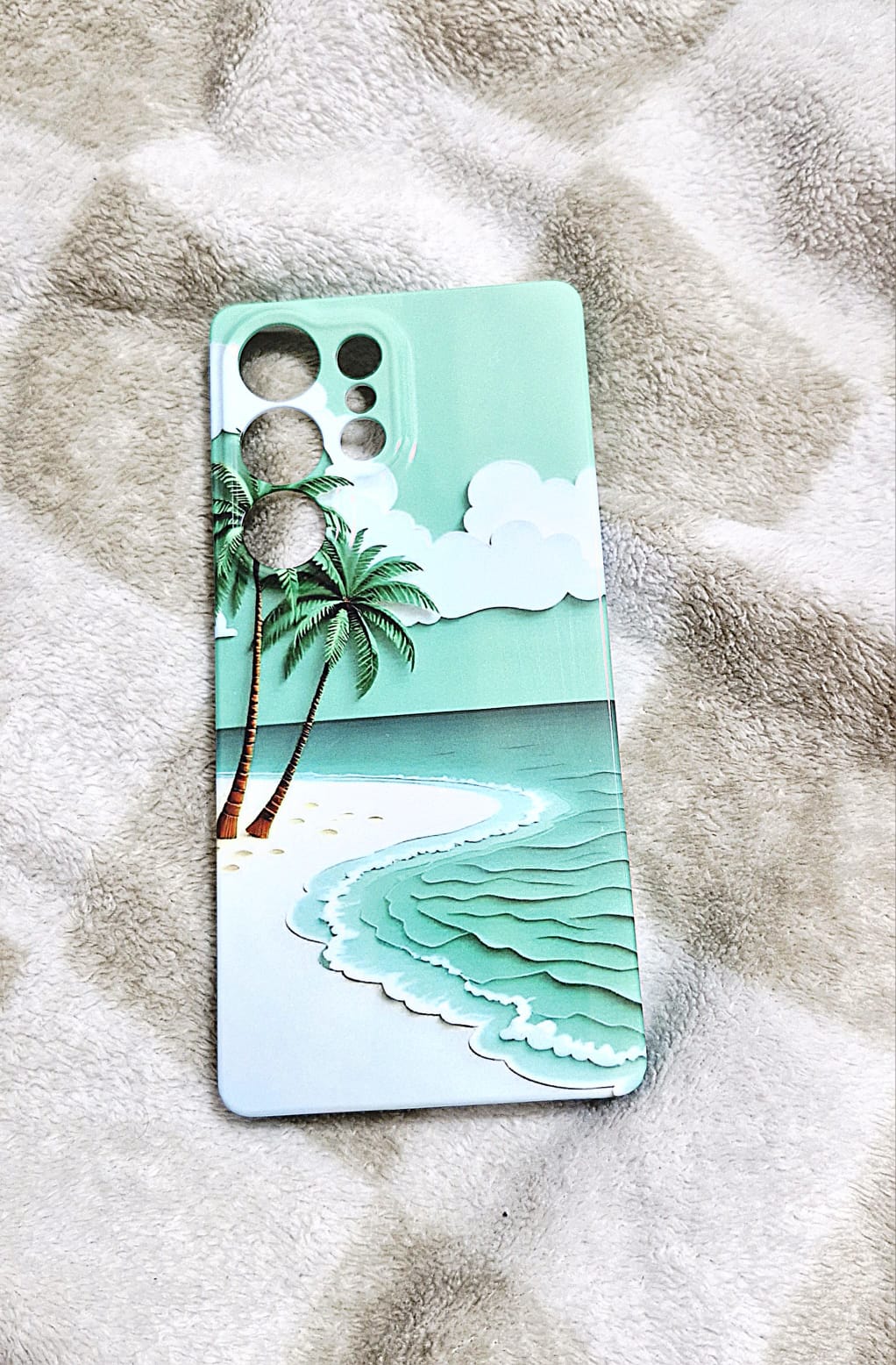 Tropical beach wave phone case flat lay on fluffy surface