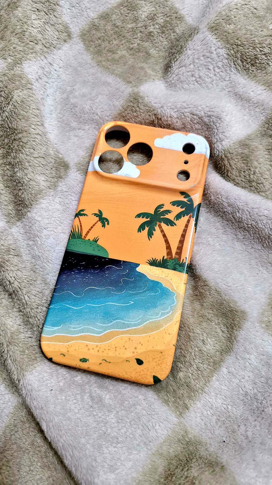 Golden hour beach phone case flat lay on fluffy surface